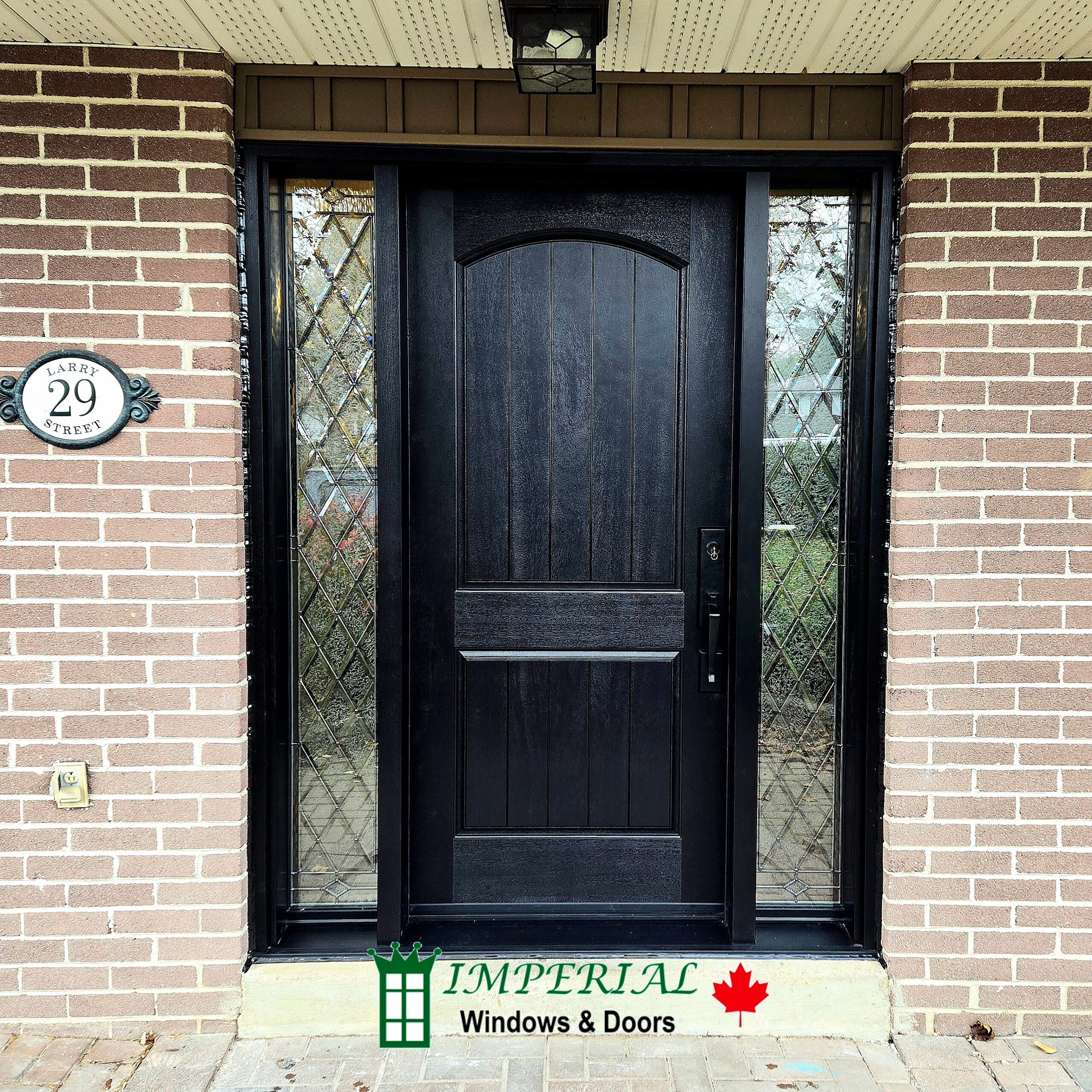 Modern black fiberglass entry door installed on a Toronto home