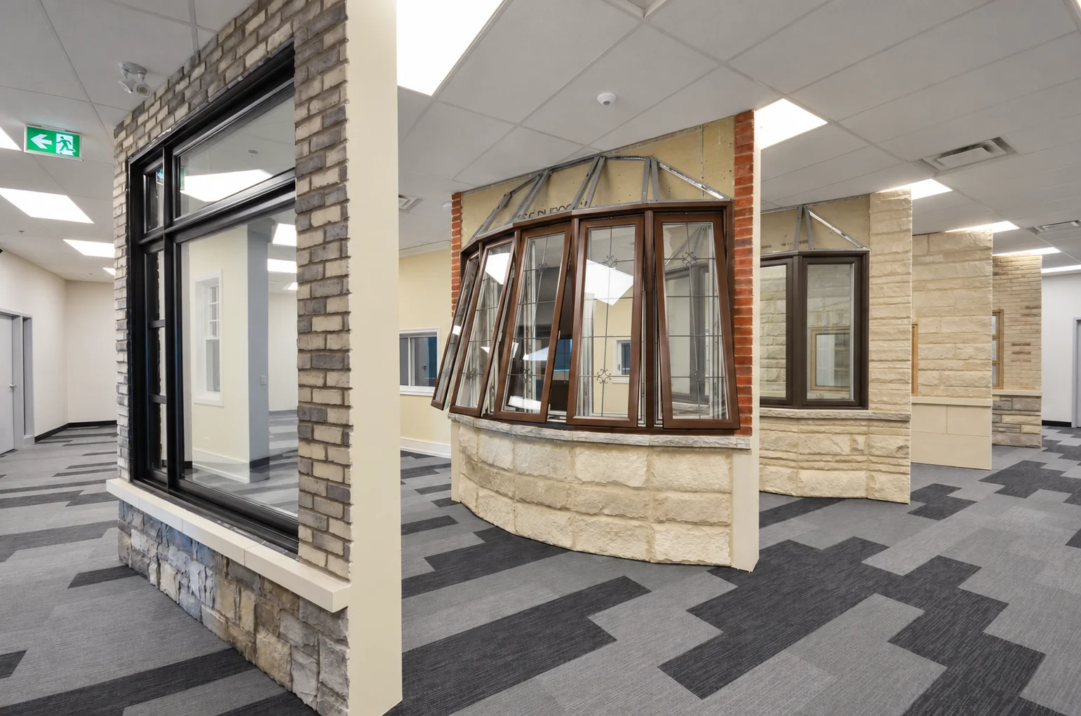Brown bay window and black picture window displayed in the manufacturer showroom