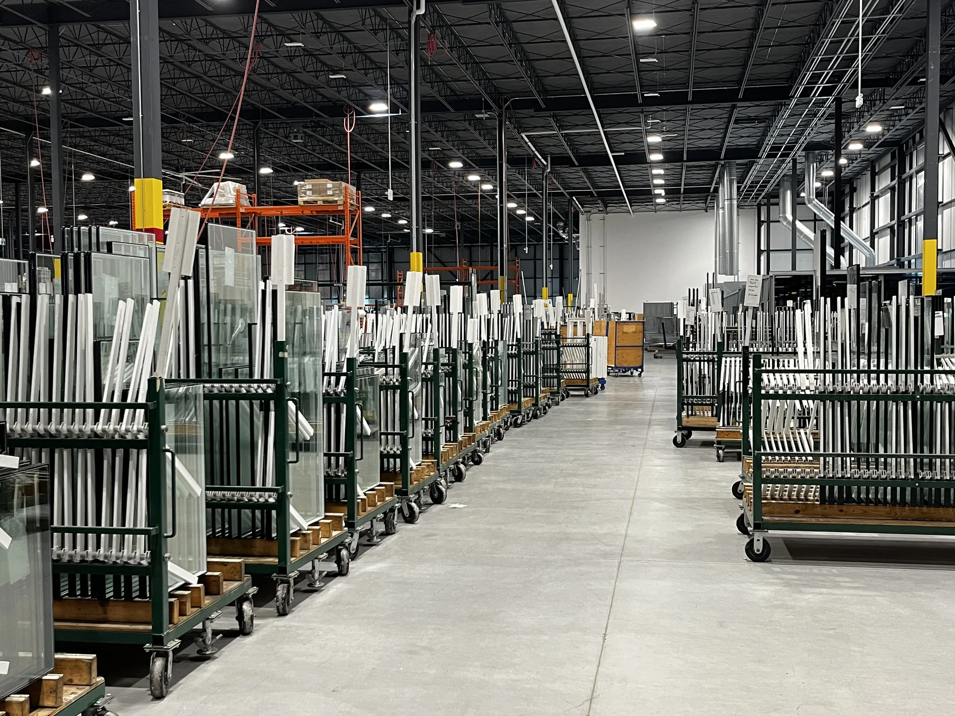Rows of window glass and frames at the Vinyl Pro production facility