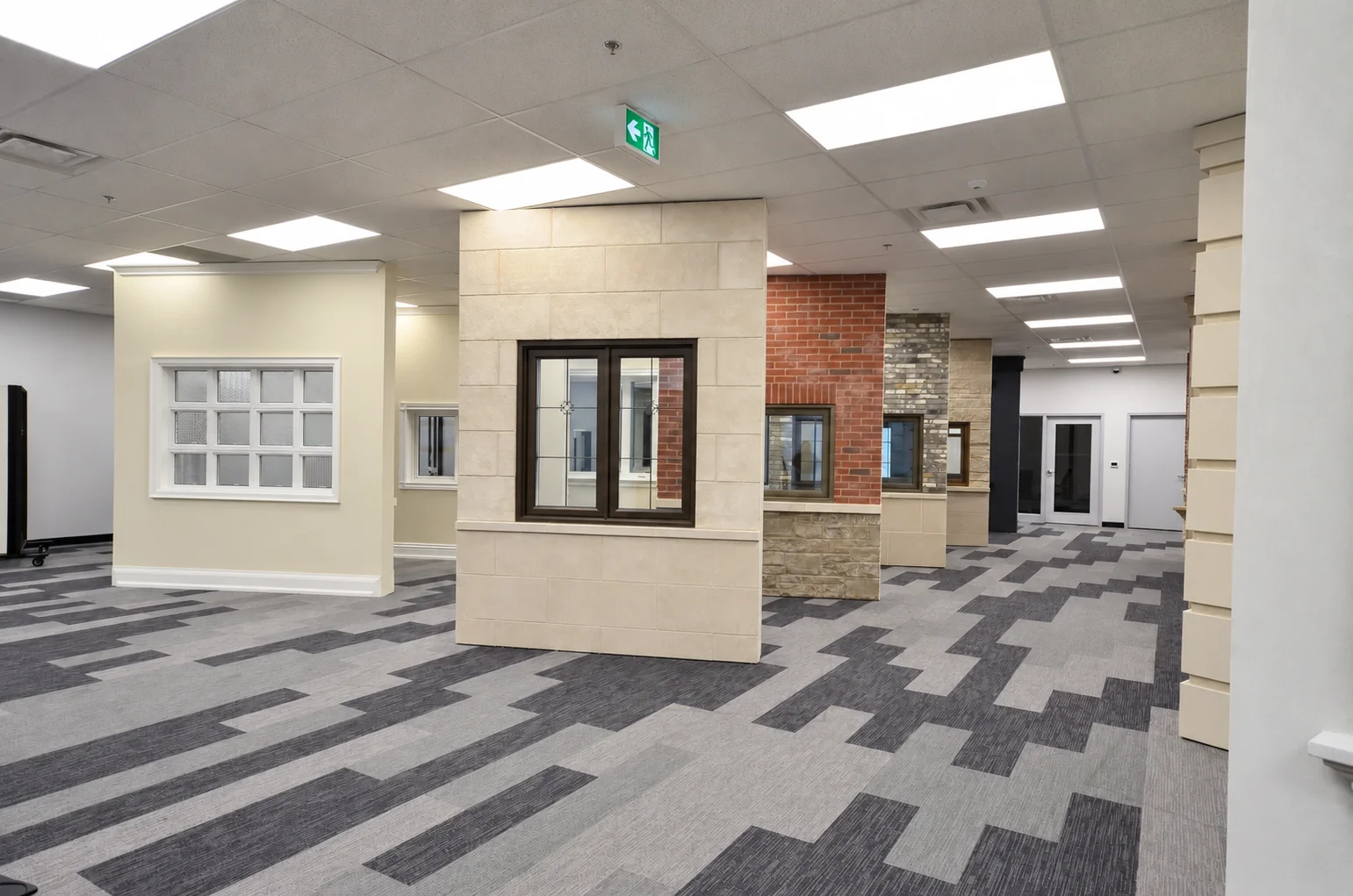 Window styles displayed with stone and brick finishes in the showroom